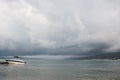 Small sport fishing white boat on approaching storm background