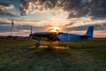 A small sports aircraft parked at the airfield at picturesque sunset Royalty Free Stock Photo