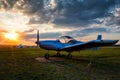 A small sports airplane parked at the airfield at scenic sunset Royalty Free Stock Photo