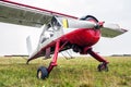 Small sports airplane for towing gliders stands on the grass Royalty Free Stock Photo