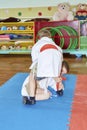 Small sportsmen train sparring on tatami