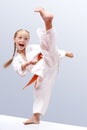 Small sportwoman is a beating circular kick leg Royalty Free Stock Photo