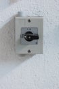 Small square electric switch box with on off markings set on a wall close up shot front view Royalty Free Stock Photo