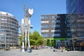 Small square in front of modern Print Media Academy building with steel sculpture horse called `S-Printing Horse`