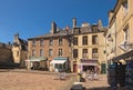 The small square lined with shops and cafes outside the entrance of the Bayeux Cathedral in Normandy, France.