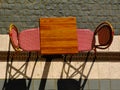 Small square restaurant table and colorful exterior chairs in top view