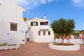 Small square with white buildings on street in Menorca. Spain