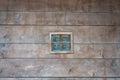 Small square window in the wall of a wooden house Royalty Free Stock Photo