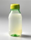 A small, squeezable plastic bottle filled with lemon juice, capped with a bright green lid, positioned at an angle Royalty Free Stock Photo
