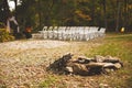 Small stack of rocks with the white chairs for the guests of the wedding ceremony in the background Royalty Free Stock Photo