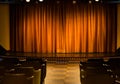 Small stage with orange curtains in cameral private cinema Royalty Free Stock Photo