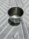Small Stainless Steel Cup on Patterned Fabric Royalty Free Stock Photo