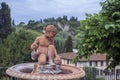 Small statue of the child in Florence in the evening