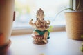 A small statue of Ganesha stands on the windowsill