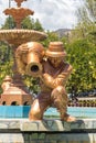 Small statue of a golden colored peasant in the pool, located in the main square of Carhuaz, Ancash - Peru