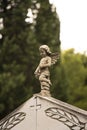 Small statue of a little angel at the gravestone at the old cemetery in Dalmatia, close up Royalty Free Stock Photo