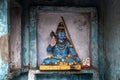 A small statue of Shiva on the background of the blue wall. Royalty Free Stock Photo