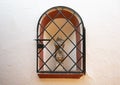 Small statue of the Virgin Mary holding the infant Jesus in a niche in a wall in the Jewish quarter of Seville, Spain.