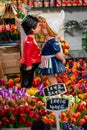 Small statues of a boy and a girl in Amsterdam market surrounded by colorful tulips Royalty Free Stock Photo