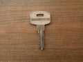 Small steel door lock key on table Royalty Free Stock Photo
