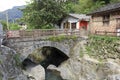 Small stone arch bridge in front of home, adobe rgb