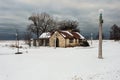 Small stone block building surrounded by snow on cold winter day with overcast sky Royalty Free Stock Photo