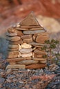 A small stone House construction with a tree in front of it on beach background Royalty Free Stock Photo