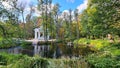 Small stone pavilion for relaxing on banks of canal in the Latvian city park Kemeri in first days of autumn 2022