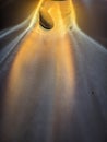?A small stone, smooth rock is illuminated by dramatic golden light rays, creating a stunning abstract and spiritual effect. Royalty Free Stock Photo