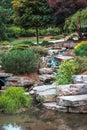 Small stone waterfall during a summer day at the Frederik Meijer Gardens in Grand Rapids Michigan Royalty Free Stock Photo