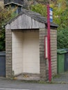 Small stone and wood bus shelter