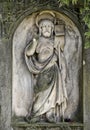 Small statue of the saint man with aureole, flag and vesture