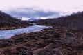 a small stream flows along a mountainous area surrounded by mountains Royalty Free Stock Photo