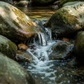 The water is clear and bubbly, cascading between the stones into a shallow pool Royalty Free Stock Photo