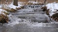 A small stream has frozen over its once gentle flow now halted by the icy grip of Mother Nature. The icy breath of the Royalty Free Stock Photo