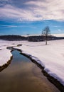 Small stream through a snow covered farm field in rural Carroll Royalty Free Stock Photo