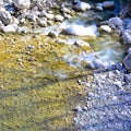 Small stream in spring, smooth rocks smoothed by the water