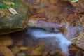 A small stream stained orange from acid mine drainage. Royalty Free Stock Photo