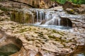 Small stream of water cascading over the rocks at the Oyster River Potholes on Vancouver Island Royalty Free Stock Photo