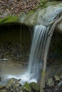 Small waterfall dropping onto rocks Royalty Free Stock Photo