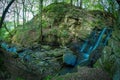 A small stream with waterfalls in the woods