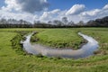 Small stream winds its way through a meadow Royalty Free Stock Photo