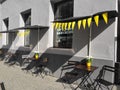 Small street cafe exterior in yellow and grey colors