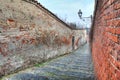 Small street among old walls in Saluzzo, Italy.