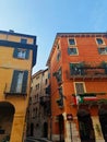 Small street in Verona with colorful houses that have Italian flags on the balconies