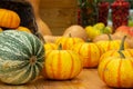 Small striped orange pumpkins harvesting a farm. Fresh vegetable on a wooden table, pumpkin, gourd, squash. Vegan and Vegetarian Royalty Free Stock Photo