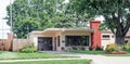 Small Stucco House with Flat Roof and Flower Beds Royalty Free Stock Photo