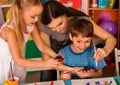 Small students finger painting in art school class. Royalty Free Stock Photo