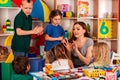 Small students girl finger painting in art school class. Royalty Free Stock Photo