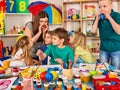 Small students girl finger painting in art school class. Royalty Free Stock Photo